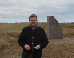 Dr. Stefan Huck,  Director, German Naval Museum, Wilhelmshaven. He stands in front of the stone for the torpedo boat,  V.4., the last Jutland wreck found. In March 2016. 